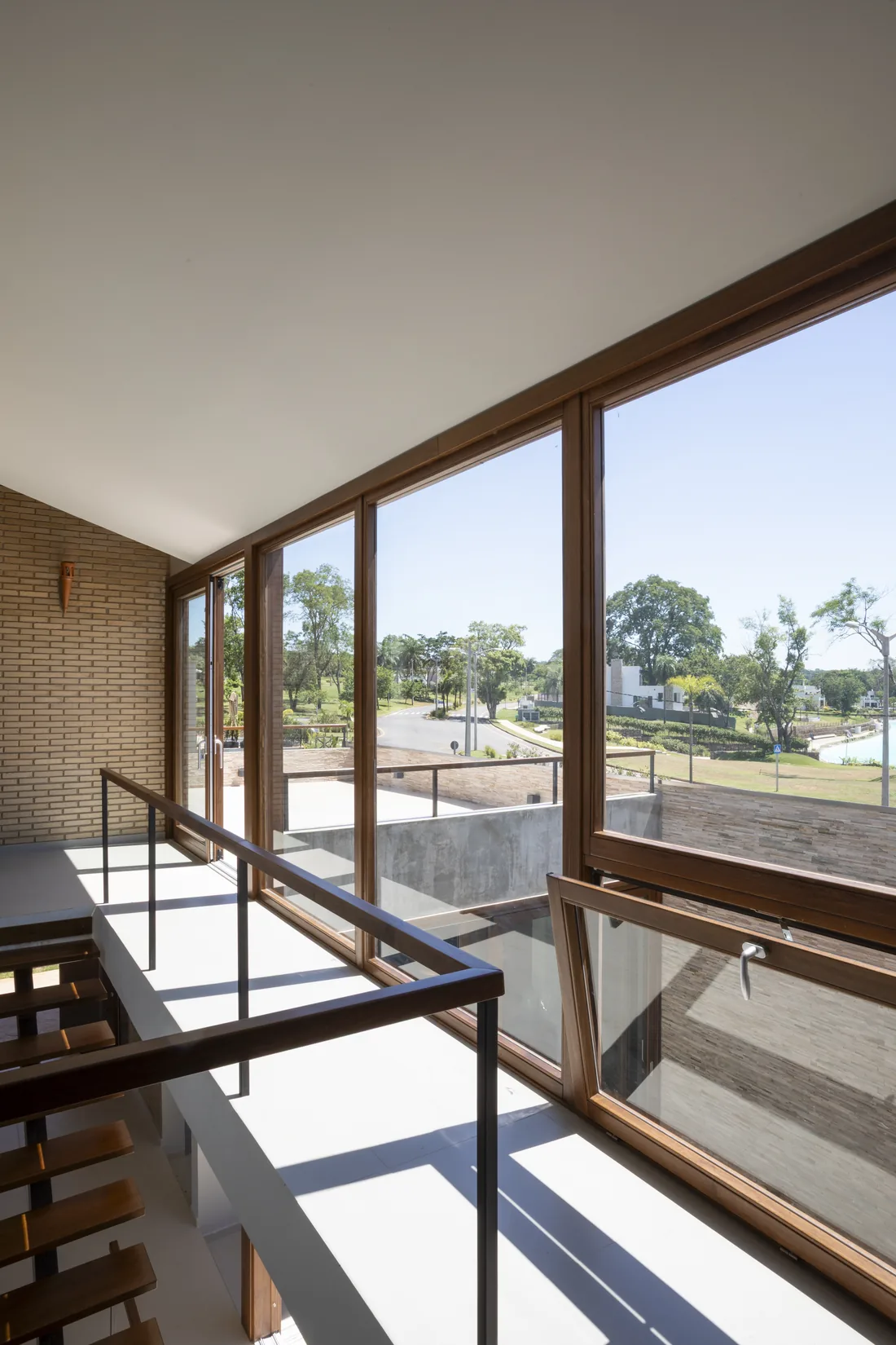 Ventanal de madera de Casa Naciente con vista al parque